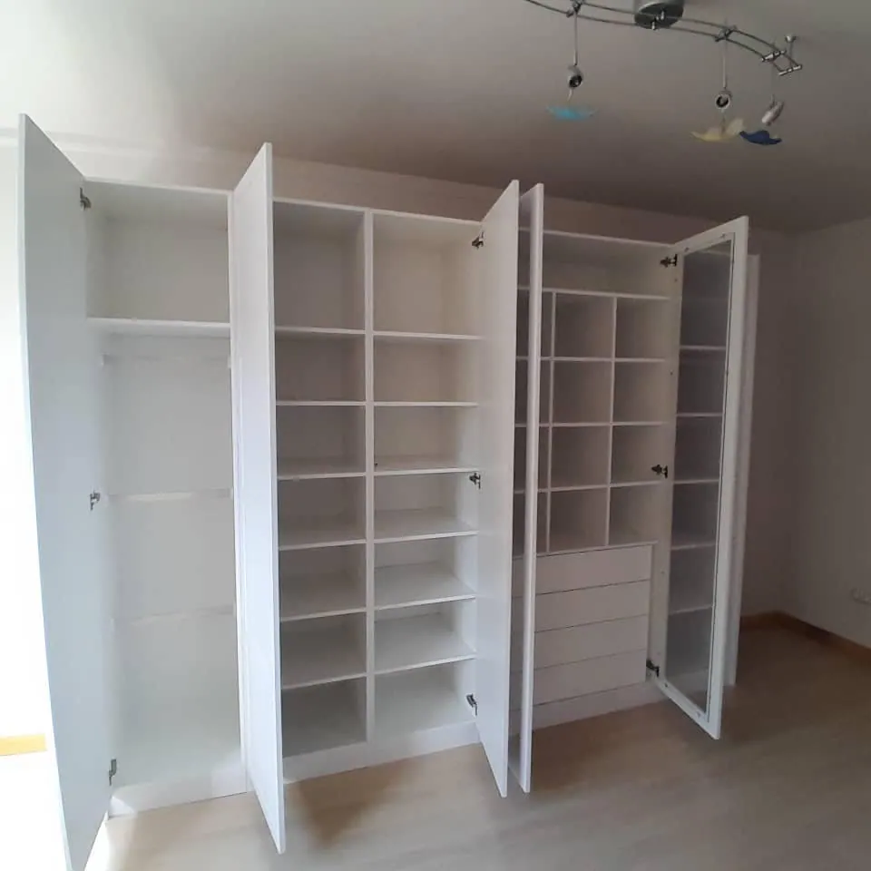 White hinged-door wardrobes, doors open