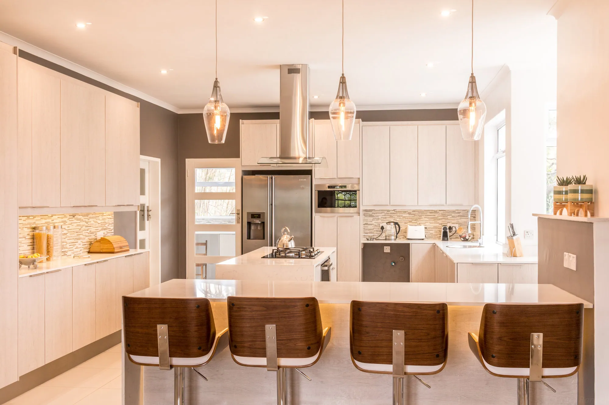 Kitchens 4 Africa kitchen with a large island, pendant lights and bar seating